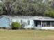 Light blue manufactured home with a screened porch at 31029 Nocatee Trl, Sorrento, FL 32776