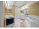 Bathroom with tub, double vanity, and toilet at 4575 S Atlantic Ave # 6209, Ponce Inlet, FL 32127