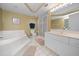 Bathroom with soaking tub and double vanity at 4575 S Atlantic Ave # 6209, Ponce Inlet, FL 32127