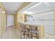 Kitchen with breakfast bar, white cabinets, and appliances at 4575 S Atlantic Ave # 6209, Ponce Inlet, FL 32127