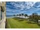 Ground level grassy area with ocean view and palm trees at 4575 S Atlantic Ave # 6209, Ponce Inlet, FL 32127