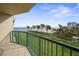 Spacious balcony overlooking a beautiful ocean view with grassy area and palm trees at 4575 S Atlantic Ave # 6209, Ponce Inlet, FL 32127
