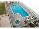 Community pool and spa with surrounding lounge chairs at 4575 S Atlantic Ave # 6209, Ponce Inlet, FL 32127