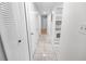 Bright hallway with light tile floors and doors at 4878 S Semoran Blvd # 1502, Orlando, FL 32822