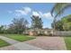 House exterior with a paved driveway and green lawn at 610 Litchfield Way, Orlando, FL 32803