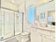 Modern bathroom with a glass shower, white vanity, and tiled floor at 6234 Sand Skipper Rd, Orlando, FL 32821