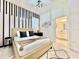 Stylish bedroom with a unique accent wall, plush bed, and an ensuite bathroom at 6234 Sand Skipper Rd, Orlando, FL 32821