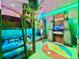 Jurassic Park-themed ' bedroom with bunk beds, vibrant lighting, and playful decor at 6234 Sand Skipper Rd, Orlando, FL 32821