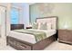 Inviting bedroom with a wooden bed frame, green accent wall, and stylish nightstands at 6234 Sand Skipper Rd, Orlando, FL 32821