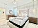Stylish bedroom with a tufted headboard, modern lighting, and wooden accents at 6234 Sand Skipper Rd, Orlando, FL 32821