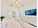 Modern bedroom with a large TV, ample storage, and a comfortable bed at 6234 Sand Skipper Rd, Orlando, FL 32821