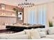Elegant dining room with a large table, modern chandelier, and seating for twelve at 6234 Sand Skipper Rd, Orlando, FL 32821