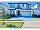 Modern two-story home with a paved driveway and landscaped front yard at 6234 Sand Skipper Rd, Orlando, FL 32821