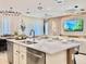 Open-concept kitchen with a large island, modern appliances, and dining area at 6234 Sand Skipper Rd, Orlando, FL 32821
