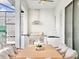 Outdoor kitchen and dining area with stainless steel appliances and wooden furniture at 6234 Sand Skipper Rd, Orlando, FL 32821