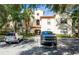Two-story condo building with Spanish-style architecture, lush landscaping, and parking at 831 Camargo Way # 203, Altamonte Springs, FL 32714