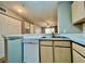 Kitchen boasts white appliances, wood cabinets, and tiled floor at 831 Camargo Way # 203, Altamonte Springs, FL 32714