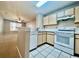 Well-equipped kitchen featuring white appliances and wood cabinets at 831 Camargo Way # 203, Altamonte Springs, FL 32714