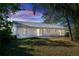 Home's rear view, showcasing a patio and grassy yard at 1073 Humphrey Blvd, Deltona, FL 32738