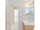 Clean bathroom with single sink vanity and access to other rooms at 1073 Humphrey Blvd, Deltona, FL 32738