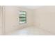 Simple bedroom with tile floors and window with natural light at 1073 Humphrey Blvd, Deltona, FL 32738