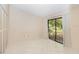 Bright bedroom with tile floors and sliding glass door leading to backyard at 1073 Humphrey Blvd, Deltona, FL 32738