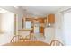 View of kitchen from dining area with wood cabinets at 1073 Humphrey Blvd, Deltona, FL 32738