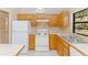 White appliances and light wood cabinets in this kitchen at 1073 Humphrey Blvd, Deltona, FL 32738