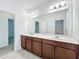 Double vanity bathroom with a large mirror at 12285 Joshua Tree Trl, Windermere, FL 34786