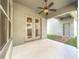 Covered patio with ceiling fan and access to backyard at 12285 Joshua Tree Trl, Windermere, FL 34786