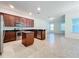 Kitchen with dark wood cabinets, stainless steel appliances, and island at 12285 Joshua Tree Trl, Windermere, FL 34786