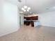 Island kitchen with dark wood cabinets and granite counters at 12285 Joshua Tree Trl, Windermere, FL 34786