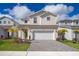 Two-story house with a white garage door and landscaping at 1230 Aloha Blvd, Davenport, FL 33897