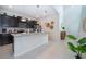 Open concept kitchen features island and stainless steel appliances at 1230 Aloha Blvd, Davenport, FL 33897