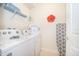 Laundry room with washer, dryer, and shelving at 1230 Aloha Blvd, Davenport, FL 33897