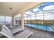 Screened-in pool and patio area with lounge chairs at 1230 Aloha Blvd, Davenport, FL 33897