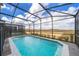 Relaxing screened-in pool with a view of the surrounding area at 1230 Aloha Blvd, Davenport, FL 33897