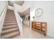 Beige carpeted staircase with wooden railing at 1230 Aloha Blvd, Davenport, FL 33897