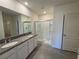 Double vanity bathroom with granite countertops and shower at 1237 Red Hill Rd, Davenport, FL 33837