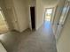 Clean hallway with tile floor and access to other rooms at 1237 Red Hill Rd, Davenport, FL 33837