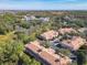 Aerial perspective of townhouses, roads, and lush greenery at 1300 Gilford Point Ln # 1300, Davenport, FL 33896