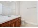 Bathroom with wood vanity, toilet and large mirror at 1300 Gilford Point Ln # 1300, Davenport, FL 33896
