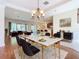 Open concept dining room with marble table and access to kitchen at 1300 Gilford Point Ln # 1300, Davenport, FL 33896