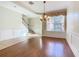 Spacious dining room with hardwood floors and adjacent staircase at 1300 Gilford Point Ln # 1300, Davenport, FL 33896