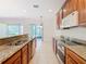 Kitchen with wood cabinets, granite counters, and stainless steel appliances at 1300 Gilford Point Ln # 1300, Davenport, FL 33896