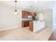Kitchen with island and wood cabinets, open to dining area at 1300 Gilford Point Ln # 1300, Davenport, FL 33896