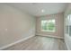 Bright bedroom with neutral walls and wood-look flooring at 13625 Sw 33Rd Cir, Ocala, FL 34473