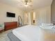 Spacious bedroom with large bed, dresser, and ensuite bathroom access at 1529 Nassau Point Trl, Kissimmee, FL 34747