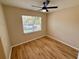 Well-lit bedroom with light walls, wood flooring, and ceiling fan at 1618 J Lawson Blvd, Orlando, FL 32824