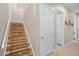 Elegant staircase with wood steps and a white railing at 19430 Sarmundham St, Orlando, FL 32833